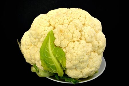 Head of Cauliflower on a black background.の写真素材