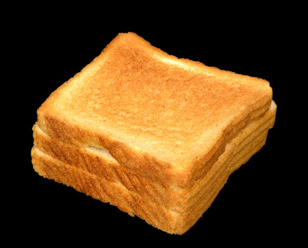 Stack of white toast on a black.
