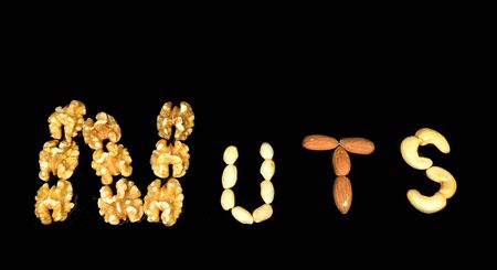 Nuts spelled out with nuts on a black background の写真素材