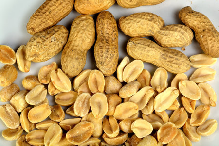 Closeup of peanuts both in the shell and shelled.