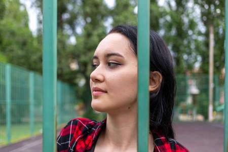 Beautiful young girl with expressive eyes on the school sports ground in the summer. High quality photoの写真素材