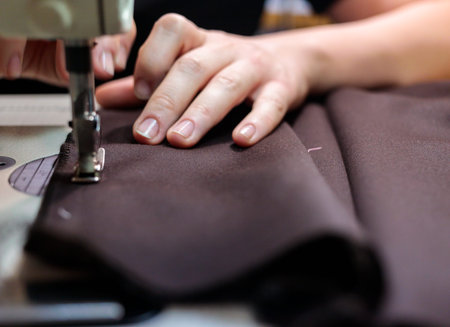 The dressmaker will open the fabric for the future costume for further work. Fashion designer tailor...