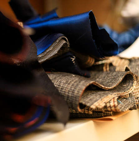 Fabric ready-made suit textile shades in the workplace, tailor or tailor, close view, atelierの写真素材