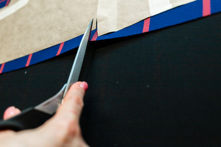 womens hands with scissors create a composition together with fabric, atelier