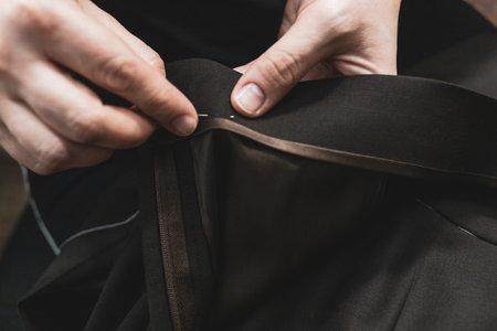 The dressmaker will open the fabric for the future costume for further work. Fashion designer tailor...