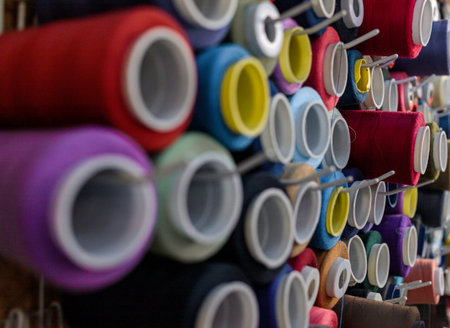 several coils of thread of different colors hang on special hooks