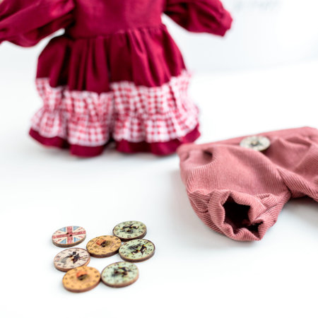 Close-up view on the creative process of sewing doll, details of doll cloth sewing machine on the...