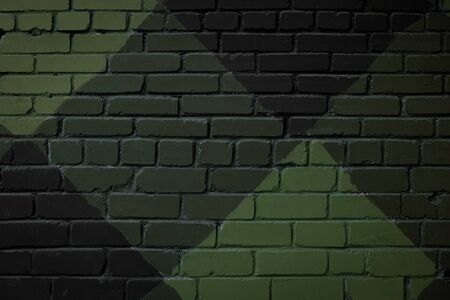 Camouflage green color brick wall texture backgroun. Surface with various squares and rhombuses. Abstract street art close upの写真素材