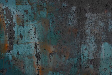 Abstract art texture background. Creative wall art close up. Beautiful dark background. Paint on the wall. Blue, gray, orange and yellow old cracked concrete wall surfaceの写真素材