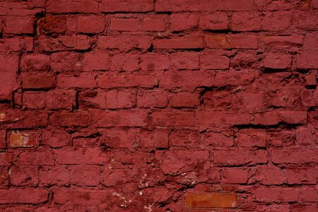 Red brick wall texture background. Old weathered and cracked red and orange bricks with white paint marks. Close upの写真素材