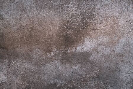 Abstract grunge texture of old colorful wall with grain and scratches. Creative background. Gray, orange and brown beautiful rough weathered stone texture. Copy spaceの写真素材