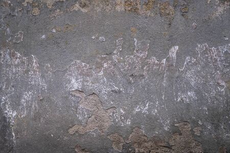 Abstract grunge texture of old colorful wall with cracks and scratches. Creative background. Gray, white and brown rough weathered stone texture with stucco and paint. Copy spaceの写真素材