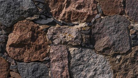 Granite stone wall texture background. Multicolor natural stones pattern. Close upの写真素材