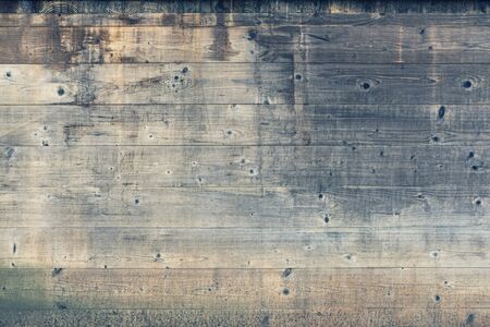 Multicolored old wooden texture background. Beautiful abstract scratched weathered gray and brown wooden wall close up. Horizontal wooden boards. Copy spaceの写真素材