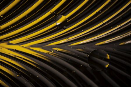 Creative abstract geometric yellow background. Chrome leaf structure with water bubbles. Molecules or cosmic spheres, planets and space. Macro shot, selective focusの写真素材