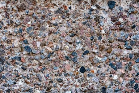 Colorful stone wall texture background. Multicolor natural small stones mosaic pattern. Close upの写真素材