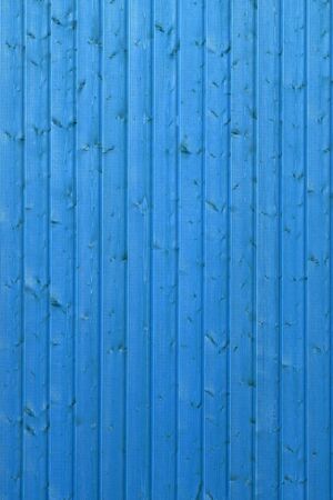 Vivid blue wooden texture background. Beautiful new bright wall surface. Vertical wooden boards. Close up with copy spaceの写真素材