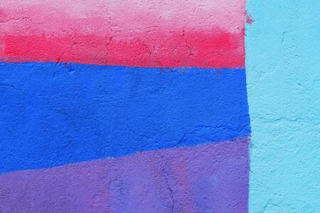 Abstract colorful wall texture background. Blue, turquoise, pink and purple rough weathered stone texture. Painted wall. Beautiful, artistic, creative background. Copy spaceの写真素材