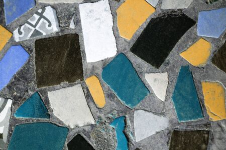 Colorful mosaic background. Blue, green, yellow, black, white and gray tiles. Abstract pattern. Old wall or floor mosaic detail. Close upの写真素材