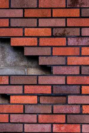 Red and gray brick wall texture background. Beautiful new concrete blocks layout. Modern construction. Vertical, close upの写真素材