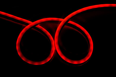 Red LED light diode stripe cable roll on black background. Modern lightning