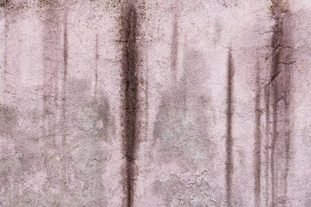 Abstract grunge texture of old purple wall with peeled off paint. Creative background. Pink, gray and purple beautiful rough weathered stone texture. Copy spaceの写真素材