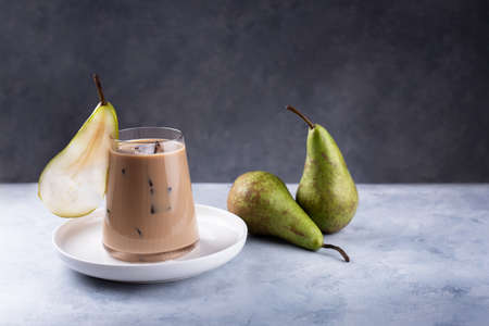 Pear Spice Latte with green pears on a gray background, close up.の写真素材