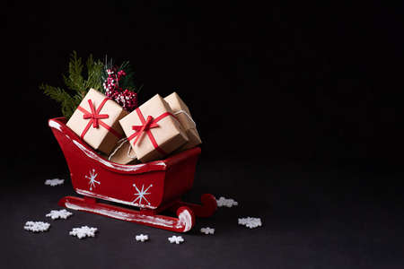 Red Santa's Sleigh with gifts on a dark background, Christmas concept, copy space.の写真素材