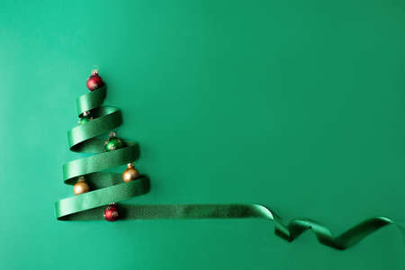 Christmas tree made of green ribbon and baubles, Christmas greeting card, close-up.の写真素材
