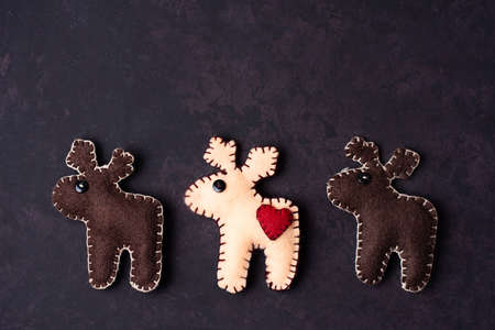 Three reindeer sewn from felt, DIY Christmas decoration, close-up.の写真素材