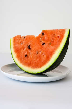 Plate with watermelon slice  isolated on white backgroundの写真素材