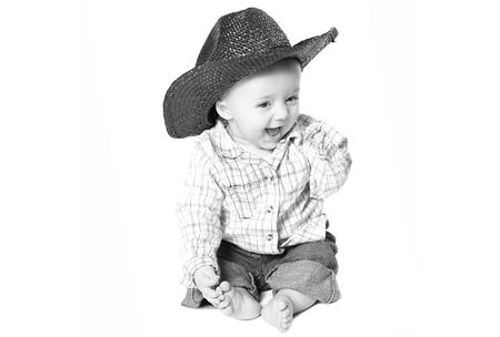 smiling baby boy with a cowboy hat.の写真素材