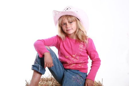 Adorable little girl wearing a pink cowboy hat.の写真素材