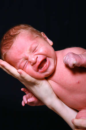 Newborn baby boy screaming.の写真素材