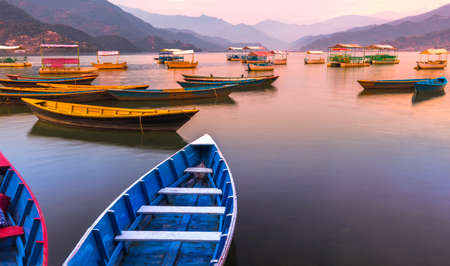 Different color Boats parked in Phewa Lake Sunset on background.Pokhara Nepalのeditorial素材