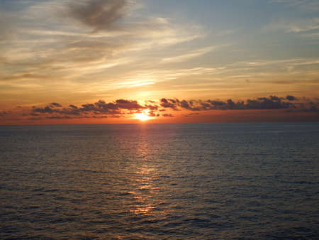 Distant sunset reflected on the waterの写真素材