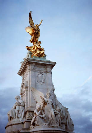 Golden statue of a winged woman, part of the sculpture of Queen Victoria in Buckingham Palaceの写真素材