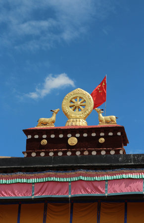 Gilded deers with dharmacakra on the top of roof at Jokhang Temple in Lhasa, Tibet, China