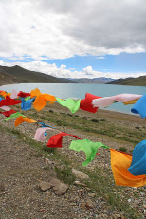 Yamdrok Lake and the prayer flags in windy day, Tibet, Chinaの写真素材