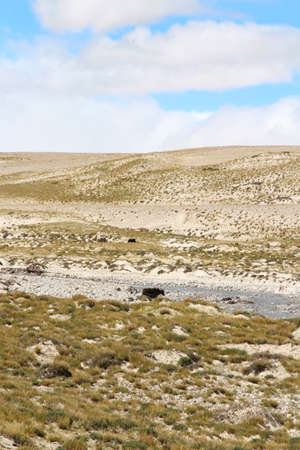 View of the mountains and river with dramatic sky on the way to Everest Base Camp, Tibet, Chinaの写真素材