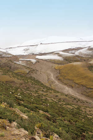 View of mountains with the dirt road in Tibet, Chinaの写真素材