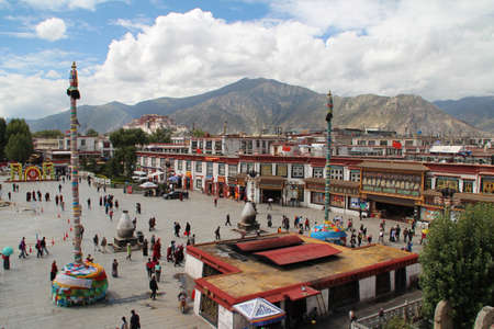 Tourists and pilgrims walking around the Jokhang square in front of Jokhang temple.のeditorial素材