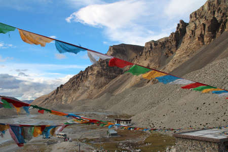 View of mountains with the sutra streamers, bus and tourist at Everest Base Camp, Tibet.のeditorial素材