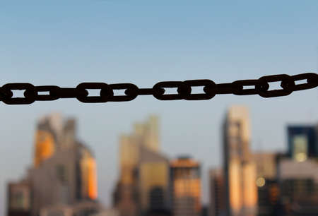 Focus on chain link across Singapore skyline as blur background from Chinatown in sunsetのeditorial素材