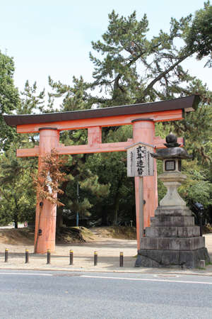 Japanese Torii Gate at Kasuga-taisha and a stone lantern in sunny spring day, Naraのeditorial素材