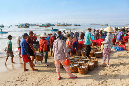 Mui Ne, Vietnam - June 27, 2017: Crowded scene of daily early morning fish market on beachのeditorial素材