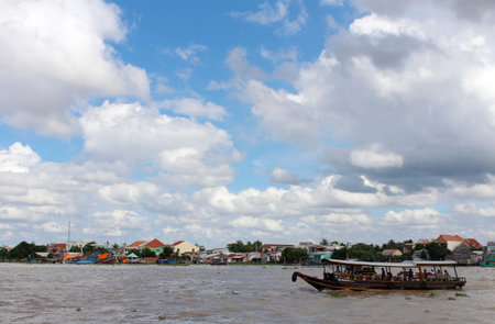Mekong River, Vietnam - June 25, 2017: View of Mekong River with the dramatic cloudscape and the boat with the tourists in a sunny dayのeditorial素材