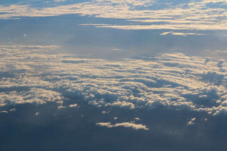 Cloud texture and blue sky during sunrise viewed from airplaneの写真素材