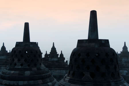 Silhouette Borobudur Temple with the mysteries forest surrounding at dawn, Yogyakarta, Indonesiaの写真素材