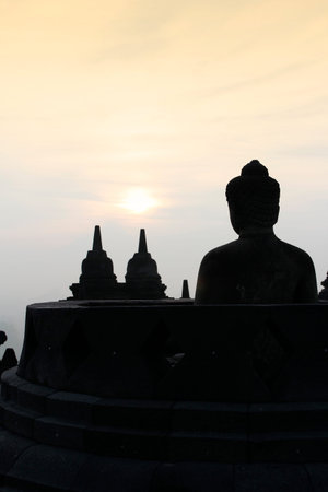 Borobudur Temple with the Buddha statue during sunrise, Yogyakarta, Indonesia